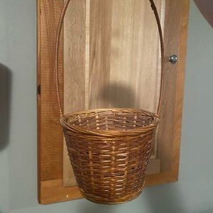 Small brown basket. Longer handle. Would be perfect for flower girl.
